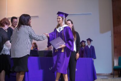 girl receiving diploma in graduation