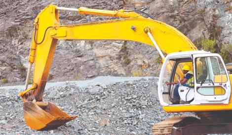 worker operating an excavator